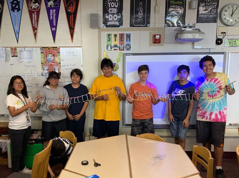 Middle School Program Scholars holding their DNA Strand Model